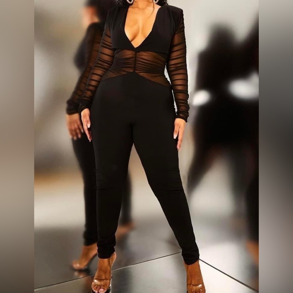 Black jumpsuit with mesh cutouts.
